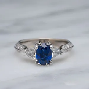 Blue Oval Sapphire with Trillion and Round Diamonds 18k White Gold Ring